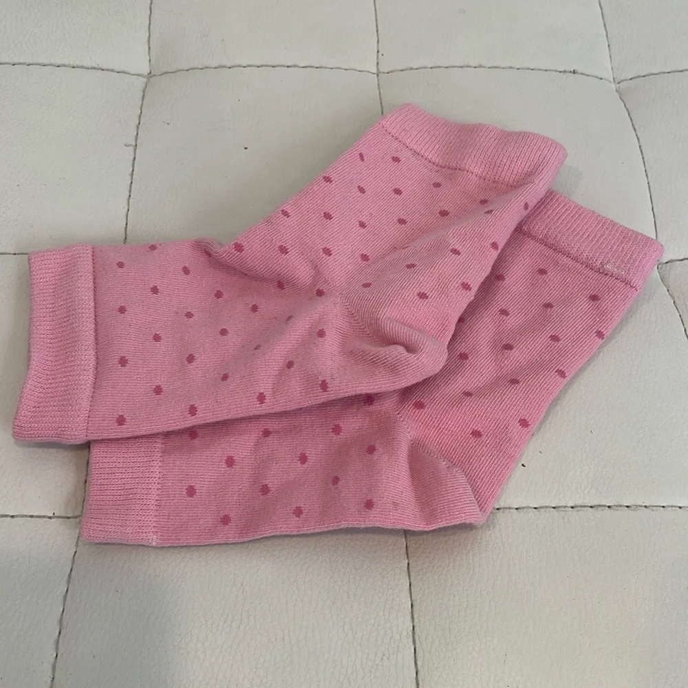 Pair of footless polka dot pink socks
